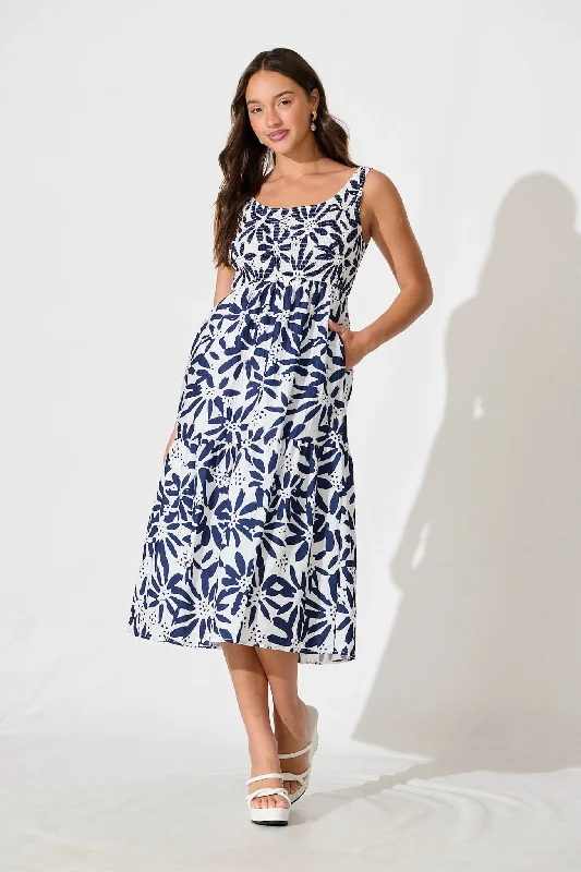 Midi dresses with embroidered accents for a unique and detailed designCaribbean Midi Dress In White with Navy Flower Midi dresses with embroidered accents for a unique and detailed designCaribbean Midi Dress In White with Navy Flower